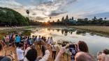 angkor wat with tourists taking photos